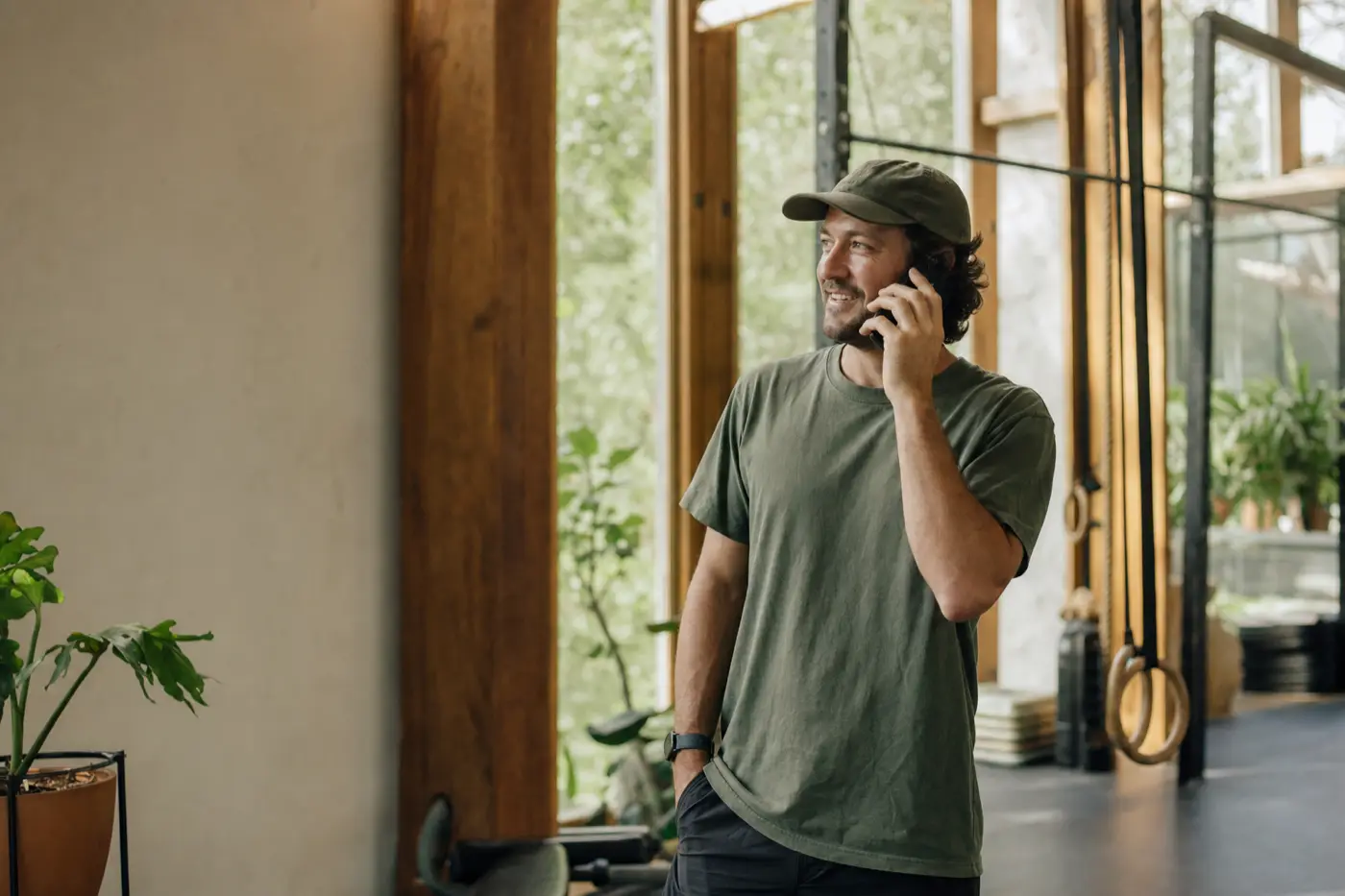 A gym owner calmly on the phone in their studio, being helped with a claim